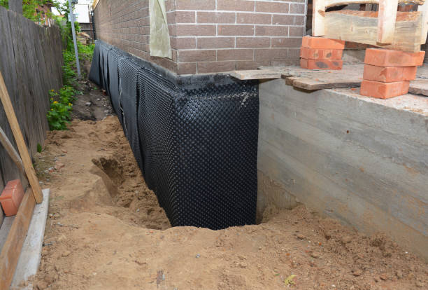 SJ Waterproofing Pros technician performing targeted Waterproofing assessment in Burket, IN